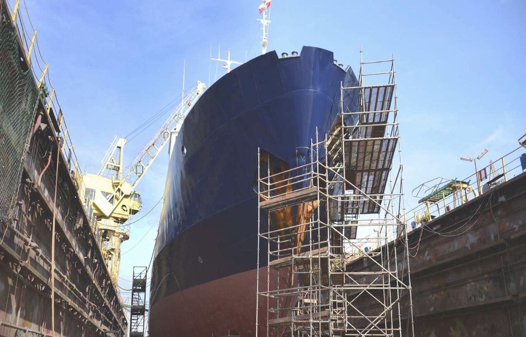 A large vessel being serviced in a port