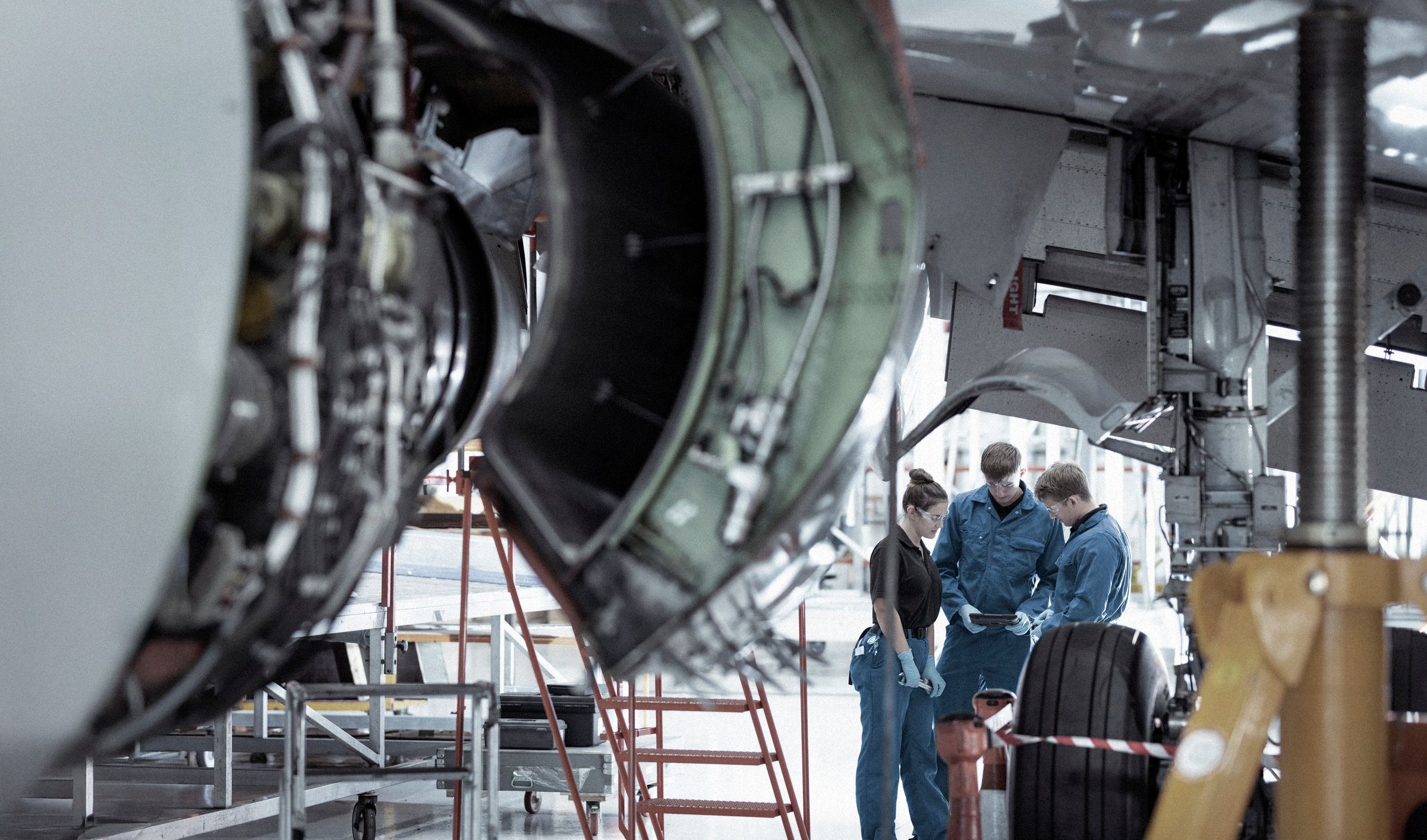 Aerospace engineers consulting in a hanger