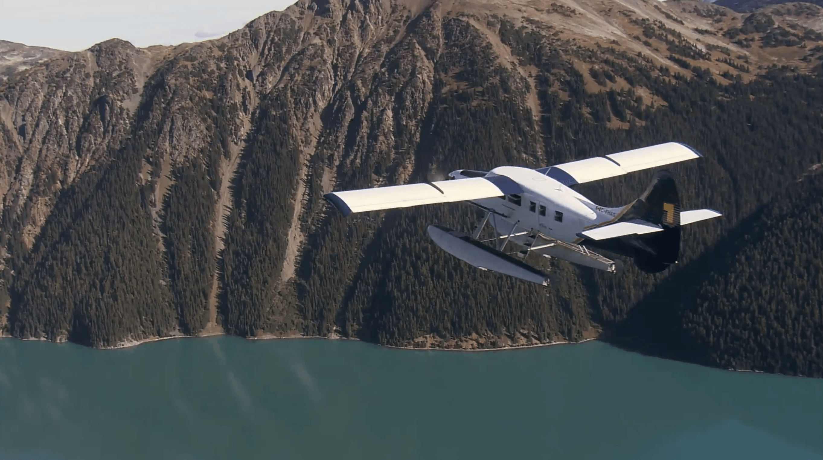 Seaplane flying over scenic mountains